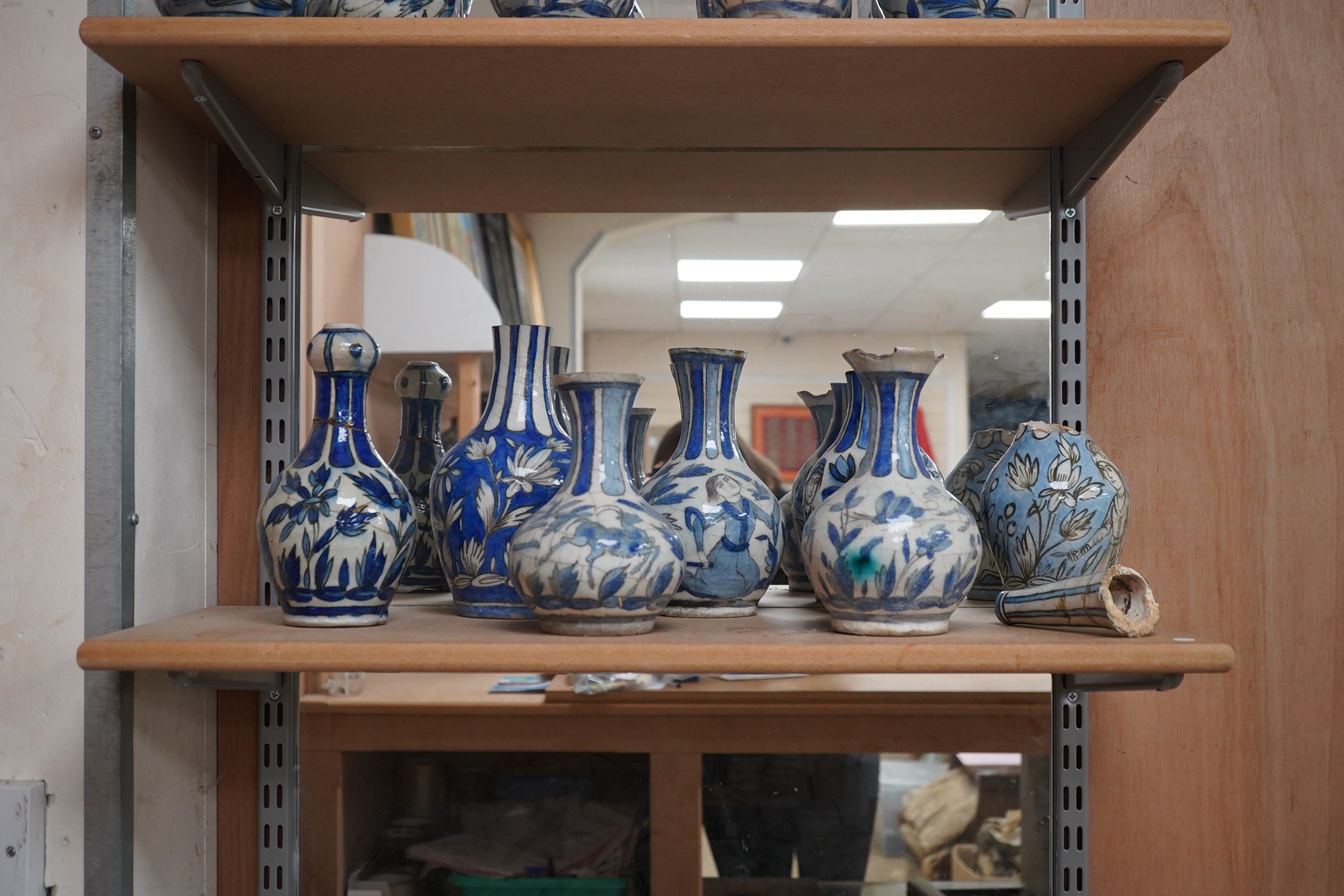 A large collection of Persian, predominantly blue and white, guglets, 18th century, largest 21.5cm. Condition - mostly damaged